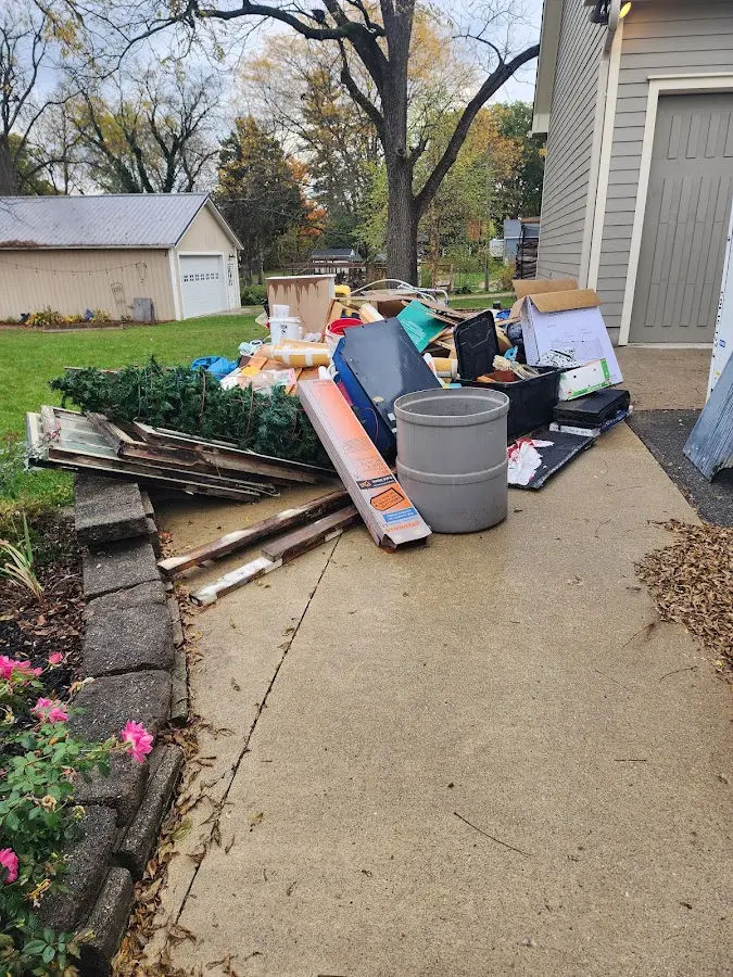 Dumpster being loaded with debris for Estate Cleanout Dumpster Rental in Richland Hills